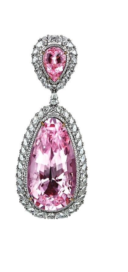 carats of Oval ruby strings suspended from floral diamond motifs grace the