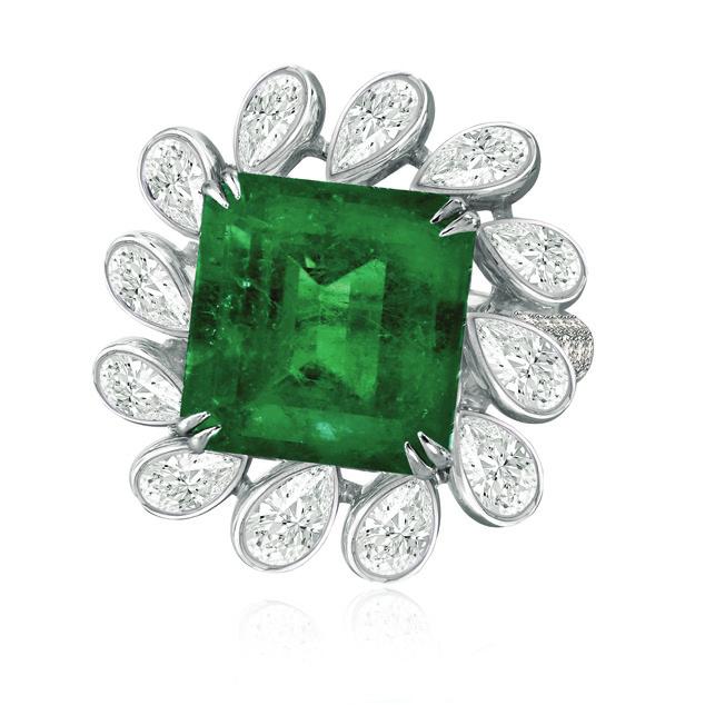 floral ring focuses on an 11-carat emerald surrounded by 8 carats of