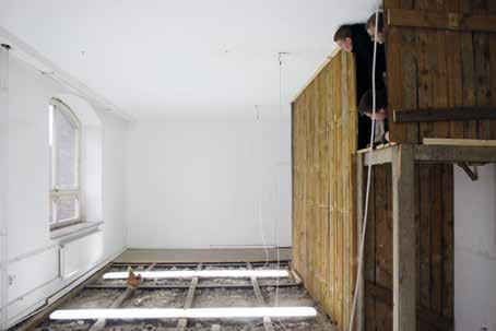 The lighting was taken down to the floor after the floorboards were widely pulled out and shifted upwards to create a wooden shack that could be entered through the main door.