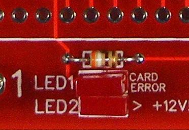 Once all the switches are flush, finish soldering the other pins. Step 13: Solder in the two red LEDs into LED1 and LED2. Note: The shorter pin is pin 1 and goes in the hole with the square pad.