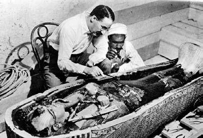 Archaeologist Howard Carter (left) examines the coffin of King Tutankhamen, which he discovered in 1922. King Tut was buried in a series of three coffins, one inside the other.
