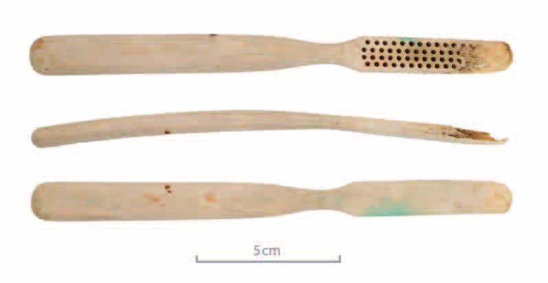 Figure 37. The bone toothbrush found in Feature 25. Figure 38. Three bottles with the remains of paper labels. Left: A Cognac bottle from JAs Hennessy & Co., from Feature 4.