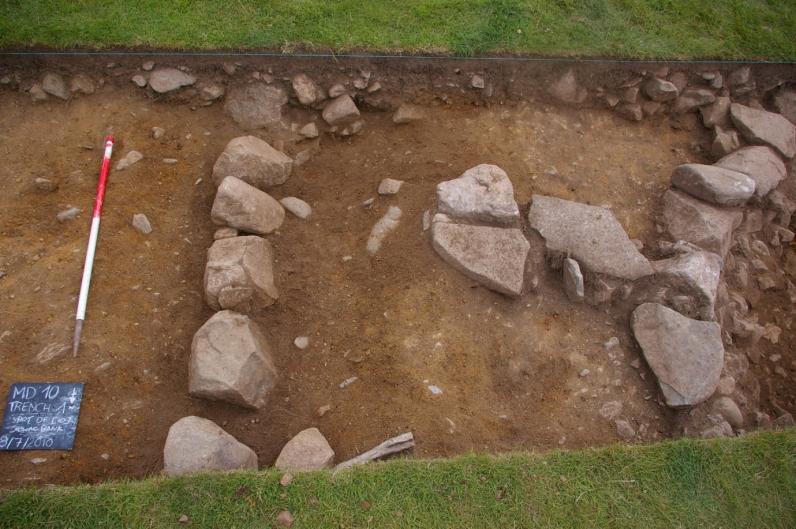(31). This latter feature was sealed by a later stone structure (29) which was contemporary with the later stone roundhouse wall (06) (see Figure 7).