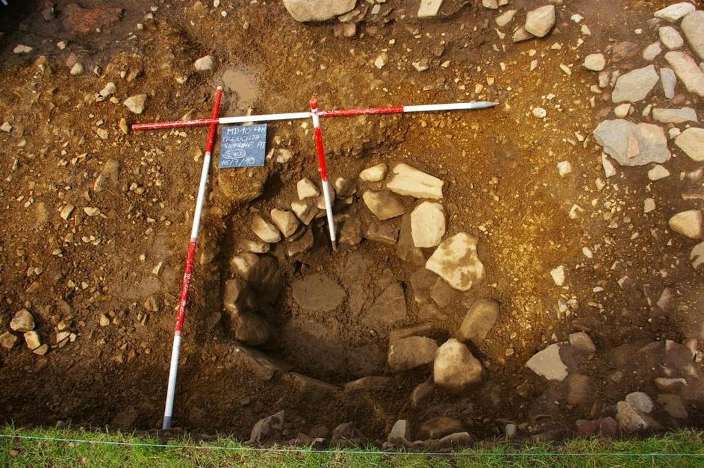 The occupation floor within the roundhouse comprised of a soft dark brown/black silt (110), which c. 0.10m 0.