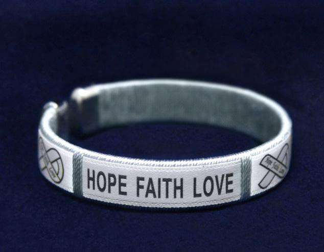 Sterling silver plated bracelet that has charms that say, Hope, Faith, Love along with ribbon charms.