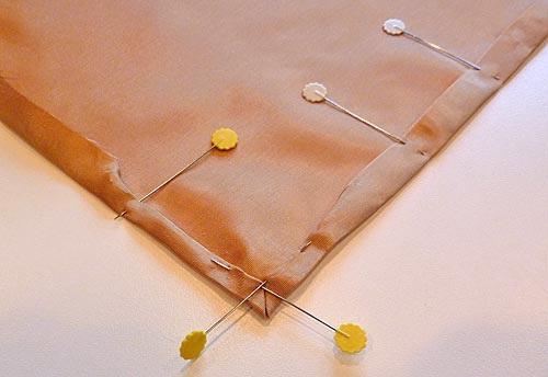The folded hem apart from the corner remains a single ½" pressed fold as shown in the photo above.