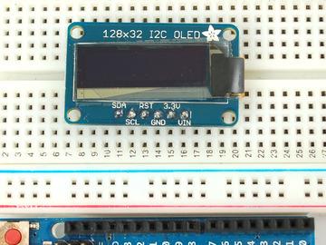 Plug the header long end down into a breadboard Place the OLED on