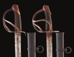154 155 154 TWO CONTINENTAL CAVALRY SWORDS, SECOND QUARTER OF THE 19TH CENTURY each with curved blade double-edged at the tip and formed with a long broad fuller on each side, stamped with a mark at