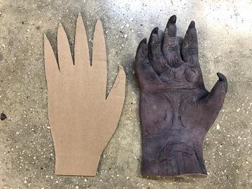 If your gloves are already very stiff and springy, skip this first step. Cut a rectangle of cardboard approximately the same dimensions of your glove.