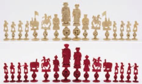 591 596 591 A Cantonese carved ivory Mandarin pattern chess set one side stained red, the other left natural, raised on puzzle ball bases, the king, 12.25cm. high, the pawn 6.5cm. high, some losses.