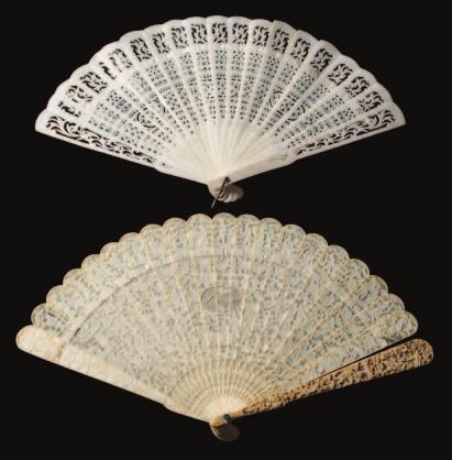599 A Cantonese carved ivory brise fan decorated to both sides with figures in pagoda landscapes, the central cartouche carved Souvenir, with similar decorated guards, 19cm.
