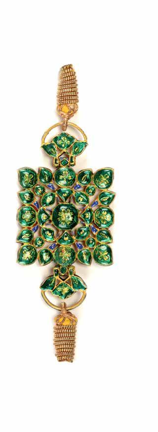 A gold wire cord on either side is attached to a flower shaped hinge, kundan set with diamonds and emeralds.