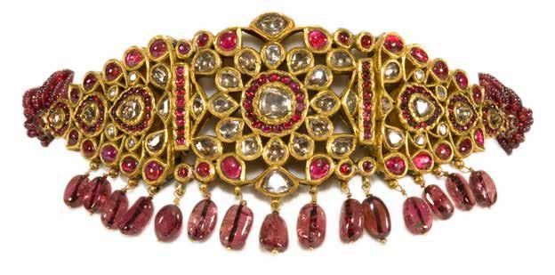 Ruby and tourmaline beads are suspended form the jewel.