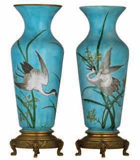 LOT 598 A pair of neoclassical gilt biscuit covered vases, decorated with putti, lions and garlands,