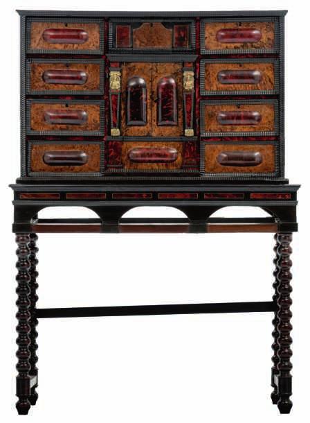 ebony and ebonised wooden, tortoiseshell and rosewood veneered cabinet-on-stand, the central doors surrounded by drawers and enclosing a