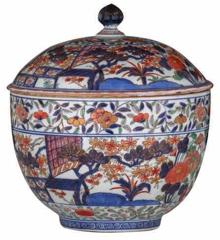 54 LOT 229 A large Japanese Arita Imari covered bowl, decorated with a pavilion in garden