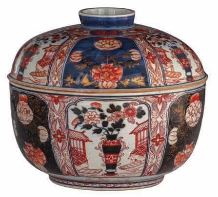 LOT 230 A large Japanese Arita Imari covered bowl, decorated with panels filled with a