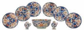 Imari plates, decorated in the centre with a willow near a lotus pond, the border with