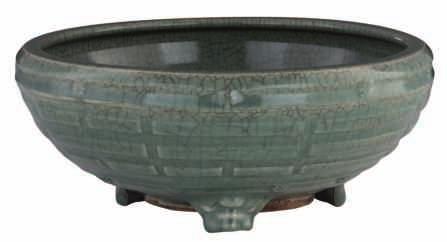 302 A Chinese celadon glazed incense burner on three animal shaped feet, the outside decorated