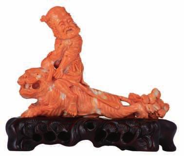 LOT 417 A finely carved piece of red coral, depicting a Fu lion with a cup on a matching wooden base, possibly Qing, H 12,7 (with base) - 11 (without base) - W 13,5 cm - total weight of the coral 198