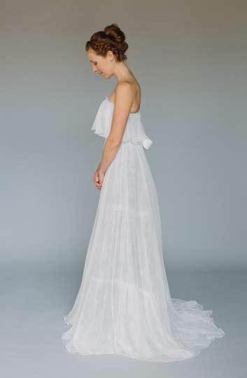 This strapless gown features a silk gauze flounce around the top edge.