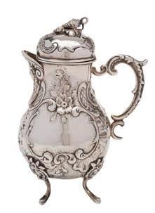 * 60-80 270 A Continental silver chocolate pot, bears import marks for London, 1893 of baluster form, with domed hinged lid and embossed foliate and scroll decoration, raised on three swept feet,