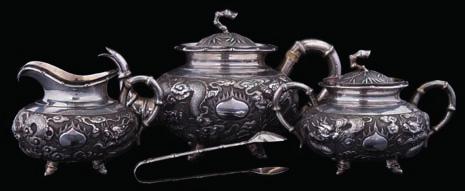* 60-80 275 A French silver cafe au lait pot and cover with hinged domed cover and urn finial, the body of baluster outline having a swept spout and turned wood handle, raised on three swept feet,