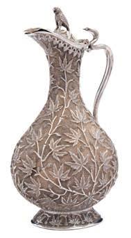 jug of ovoid form, having a hinged lid with bird finial and overall designs of grapes and vine
