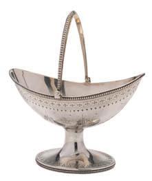 318 A Victorian silver swing-handled basket, maker Henry Holland, London, 1872 crested, of oval outline with beaded handle and border, having ribbon tied garland decoration, raised on an oval foot,