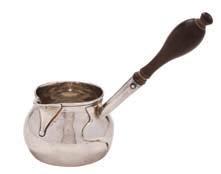 * 200-300 320 A George II silver brandy saucepan, maker George Jones, London, 1742 of cylindrical flared form, with turned wood handle on a circular spreading foot, 24cm. long, 4.95ozs.
