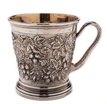 356 A Victorian silver mug, maker John Hunt & Robert Roskell, London, 1874 of cylindrical tapering outline, with embossed grape and vine leaf decoration, having a naturalistic bark scroll handle on a