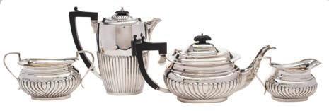 168 166 167 172 170 166 A matched George V silver three-piece tea service various makers and dates inscribed, of barge-shaped outline, with half reeded decoration, together with a