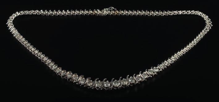 * 300-500 458 A graduated diamond tennis necklace of S link design with circular, brilliantcut diamonds estimated to weigh a total of 6.