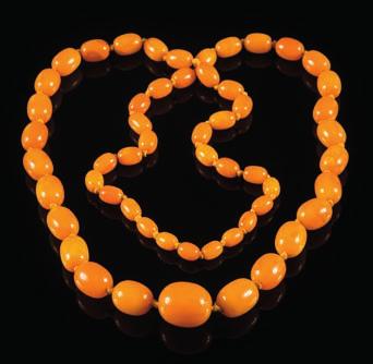 471 A graduated amber bead, single string necklace with 55 individually knotted oblong beads graduated