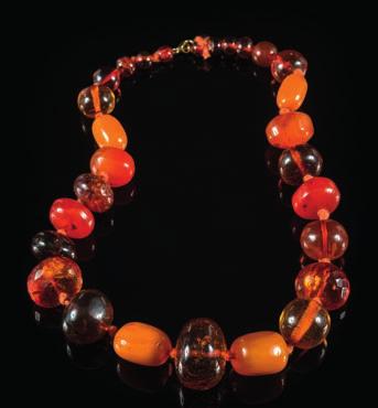 473 A multi-coloured amber bead, singlestring necklace with 28 round, oblong and faceted beads, largest bead