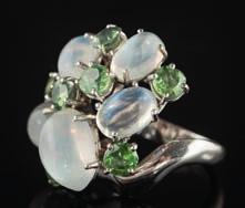* 400-500 495 A moonstone and demantoid garnet cluster ring with five oval moonstones, highlighted with seven