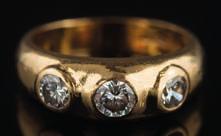 * 4000-5000 510 An 18ct gold and diamond three-stone ring with circular old European-cut and brilliant-cut