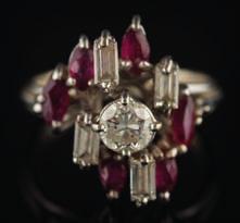 520 A diamond and ruby eleven-stone cluster ring the central circular, brilliantcut diamond approximately 0.35ct, within a surround of baguette-cut diamonds and marquise-cut rubies, 4.