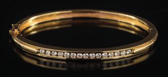 * 100-150 408 A diamond mounted hinged bangle channel-set with a line of circular brilliant-cut diamonds estimated to weigh a total of 0.