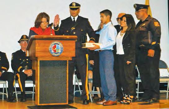 words Eddie Padilla is sworn in as Lieutenant B.A. Camille Tooker confers with the Council and City Clerk during the 10/7/15 Business Meeting.