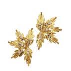 90cts 2,000-3,000 61 HA950/270 A modern diamond set brooch of foliate design the textured gold ground set at intervals with graduated round brilliant cut
