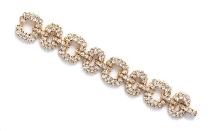 Sale 421 Lot 237 A Yellow Gold and Diamond Link Bracelet, Van Cleef & Arpels, composed of alternating fluted cushion and oval form links joined with domed bar links, the bracelet containing 241 round