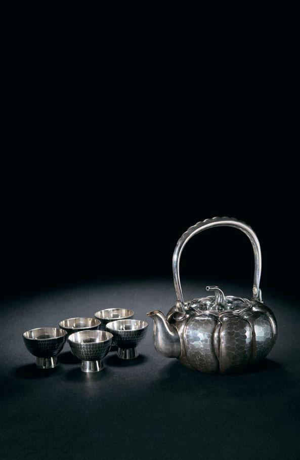 2085 SONG RONG TANG, JAPAN A SILVER JAPANESE TEA SET Circa 1980 A silver Japanese tea set with five tea cups.