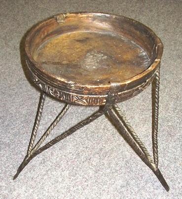 Furniture 2005.732 Tripod table stand Wood, iron / hand-crafted Iron tripod with nine twisted legs, six to hold edge of bowl, three to support underside of bowl.