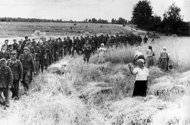 German prisoners of war marching under the supervision of Soviet soldiers, 1944.