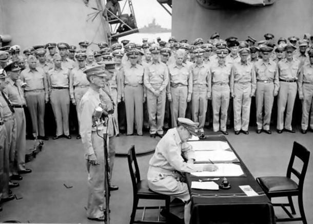 Douglas MacArthur signing the official