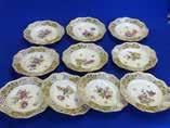Lot 38 Lot 39 38 A set of ten 19th Century Dresden style porcelain Cabinet Plates, each with gilded shaped reticulated border and individual hand decorated floral spray, blue painted AR mark to