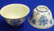 include a Saucer Dish (four-character mark to reverse), a Tea Bowl (seal mark to underside), a small lidded Pot and a small squat ovoid Vase on hardwood stand, each piece decorated with scrolling