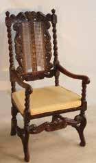 688 A late 17th Century walnut Side Chair, the shaped top rail with a small central flower head above two leaves and flanked by scrolls either side, two vertical rattan cane panels flanked by barley