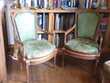 722 A good pair of Louis XVI style leather upholstered and carved walnut open armed Fauteuil, the shaped arms above fluted spiral supports and the bowed front rails flanked by turned tapering fluted